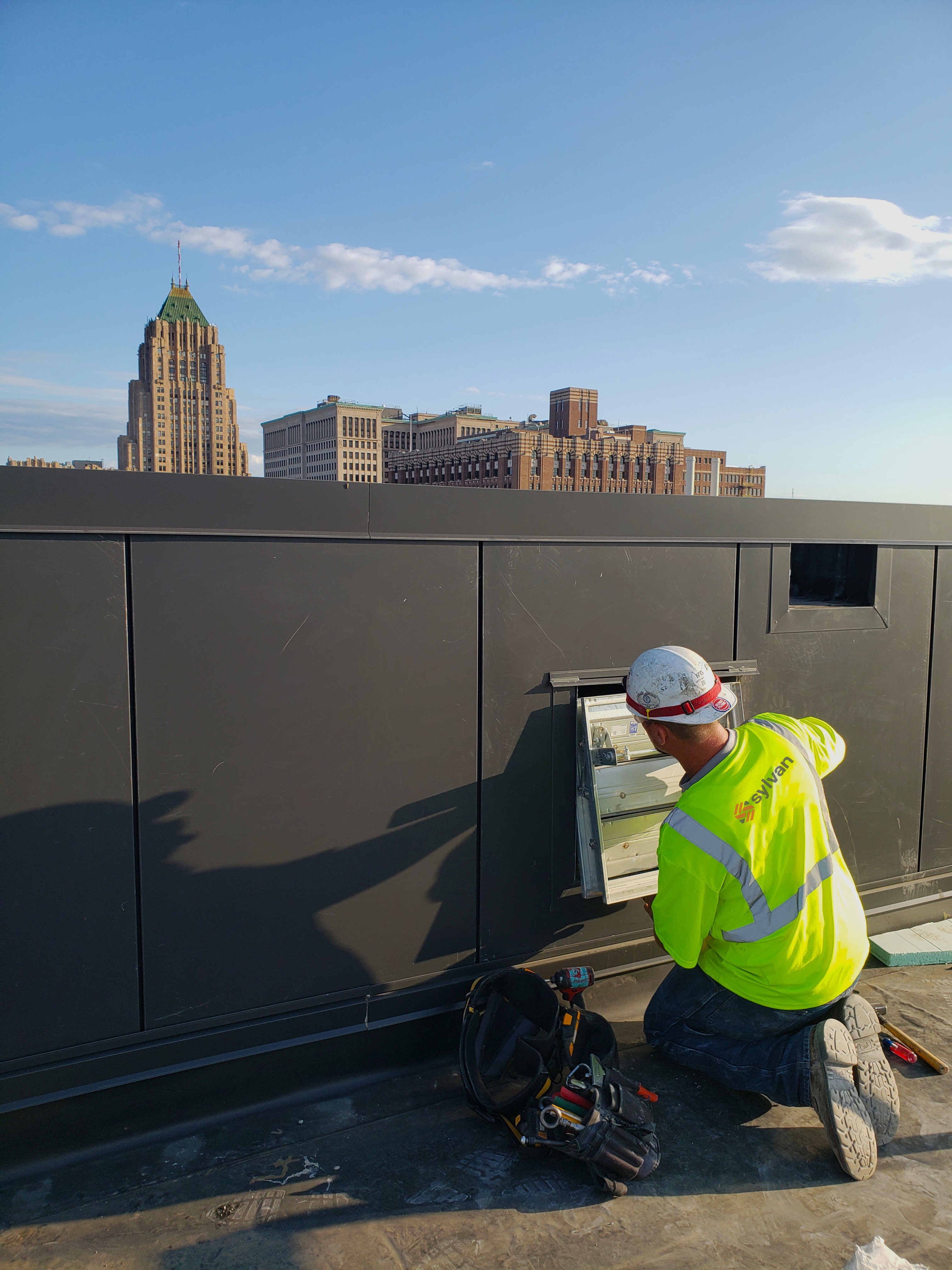 Sylvan HVAC worker installing an industrial HVAC system